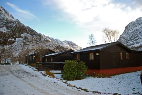 The chalet with the setting sun on the Aonach Eagach behind